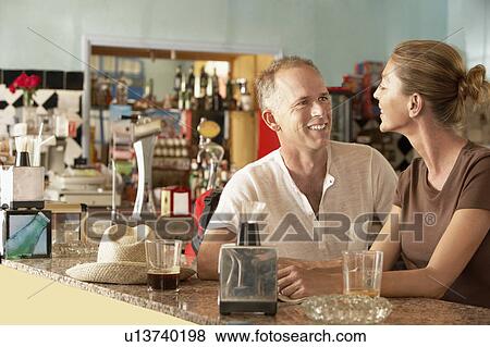 Couple sitting in bar View Large Photo Image Stock Photo - Couple sitting in bar. Fotosearch