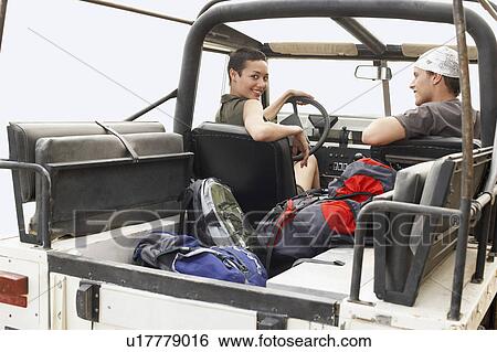 Couple sitting in four wheel drive car, outdoors View Large Photo Image Stock Photograph - Couple sitting in four wheel drive car, outdoors. Fotosearch