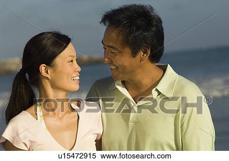 Couple smiling on beach View Large Photo Image Stock Photography - Couple smiling on beach. Fotosearch