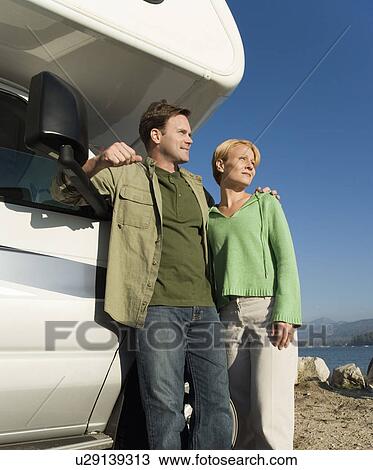 Couple standing by RV View Large Photo Image Stock Image - Couple standing by RV. Fotosearch