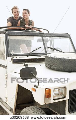 Couple standing in back of four wheel drive car, outdoors, portrait View Large Photo Image Stock Photo - Couple standing in back of four wheel drive car, outdoors, portrait. Fotosearch