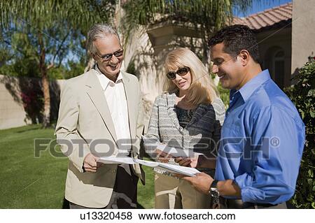 Couple with Estate Agent View Large Photo Image Stock Photo - Couple with Estate Agent. Fotosearch