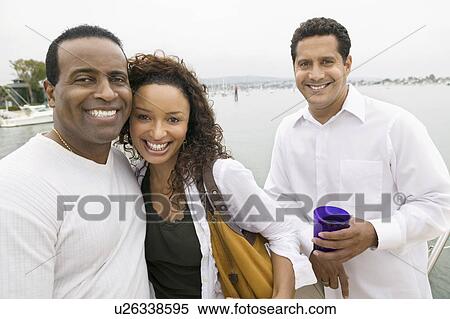 Couple with friend on yacht, (portrait) View Large Photo Image Stock Photography - Couple with friend on yacht, (portrait). Fotosearch