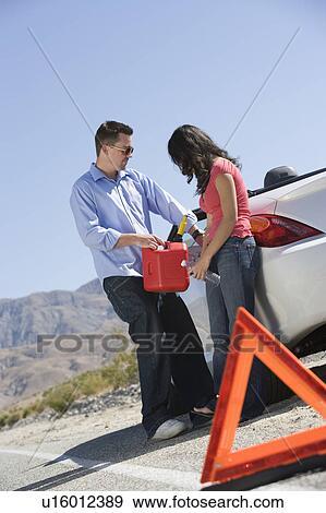 Couple with petrol canister refuel tank View Large Photo Image Stock Photo - Couple with petrol canister refuel tank. Fotosearch
