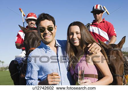 Couple with polo players, portrait View Large Photo Image Stock Image - Couple with polo players, portrait. Fotosearch