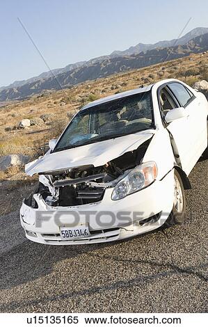 Stock Photography - Damaged car in desert. Fotosearch
