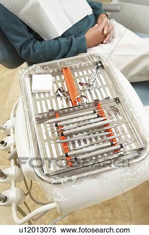 Dental tools beside man in dentists chair View Large Photo Image Stock Photography - Dental tools beside man in dentists chair. Fotosearch