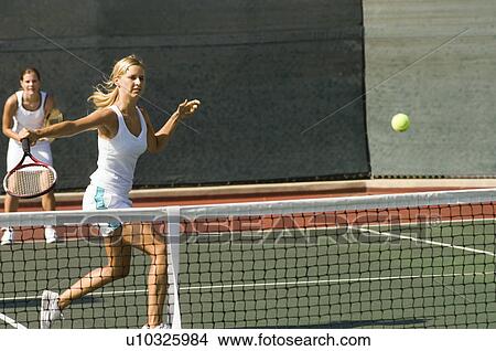 Doubles tennis Player Hitting tennis ball with Backhand View Large Photo Image Picture - Doubles tennis Player Hitting tennis ball with Backhand. Fotosearch