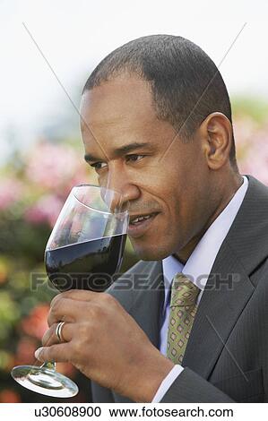 Elegant man tasting red wine, close up View Large Photo Image Stock Image - Elegant man tasting red wine, close up. Fotosearch