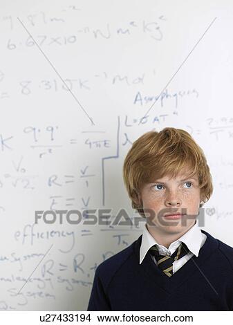 Elementary school student standing by whiteboard in math class View Large Photo Image Picture - Elementary school student standing by whiteboard in math class. Fotosearch