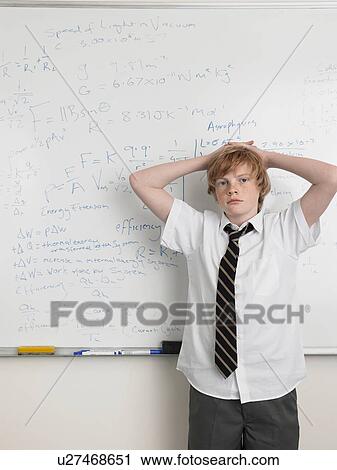 Elementary school student standing by whiteboard in math class, portrait View Large Photo Image Stock Image - Elementary school student standing by whiteboard in math class, portrait. Fotosearch