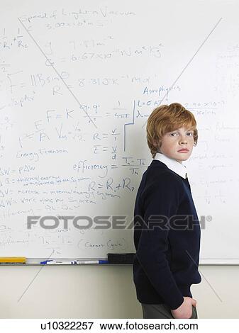 Elementary school student standing by whiteboard in math class, portrait View Large Photo Image Stock Photo - Elementary school student standing by whiteboard in math class, portrait. Fotosearch