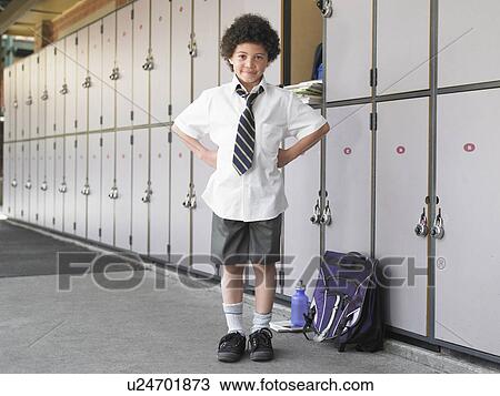 Elementary schoolboy standing by school lockers, portrait View Large Photo Image Stock Image - Elementary schoolboy standing by school lockers, portrait. Fotosearch
