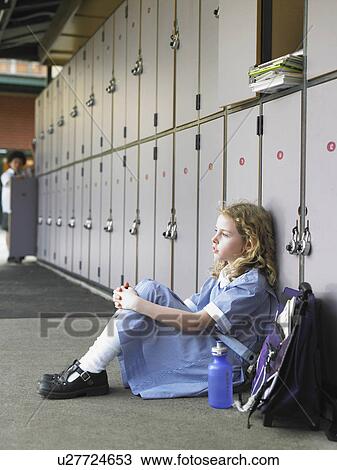 Elementary schoolgirl sitting on floor against school lockers View Large Photo Image Stock Image - Elementary schoolgirl sitting on floor against school lockers. Fotosearch