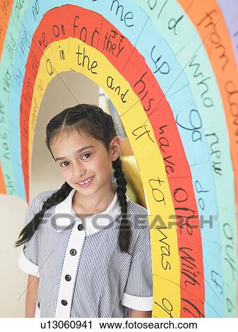 Elementary schoolgirl standing under painted arch in classroom, portrait View Large Photo Image Stock Image - Elementary schoolgirl standing under painted arch in classroom, portrait. Fotosearch