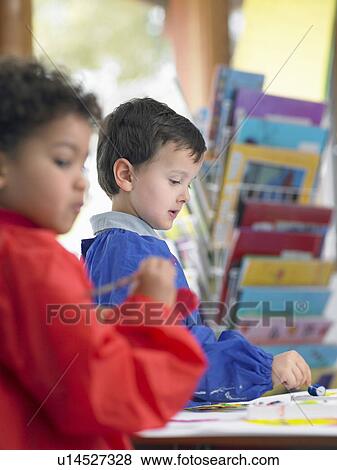Elementary students painting in art class View Large Photo Image Stock Photo - Elementary students painting in art class. Fotosearch