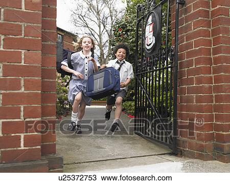 Elementary students running out through school gate View Large Photo Image Stock Image - Elementary students running out through school gate. Fotosearch