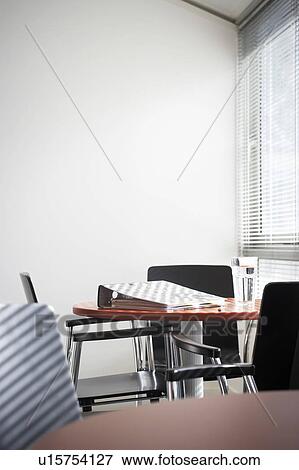 Empty office with binder and water glass on table View Large Photo Image Stock Photo - Empty office with binder and water glass on table. Fotosearch