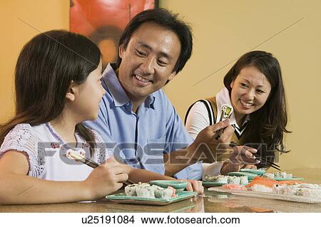 Picture - Family Eating Sushi Together. Fotosearch