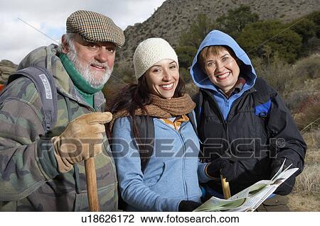 Stock Image - Family hiking in desert, (portrait). Fotosearch