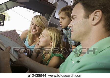 Picture - Family in RV Looking at Road Map. Fotosearch