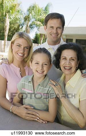 Stock Image - Family Posing Together on Backyard Patio. Fotosearch
