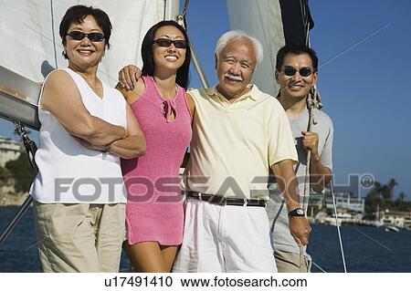 Stock Image - Family sailing, (portrait). Fotosearch