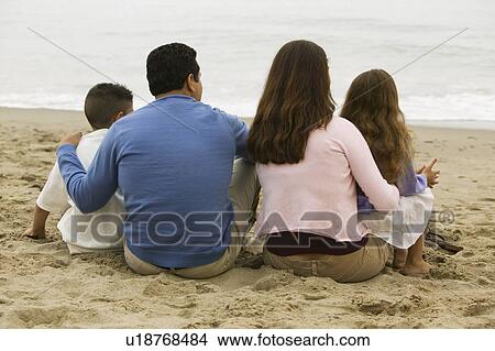 Picture - Family Sitting on the Beach. Fotosearch