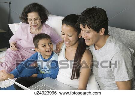 Family Using Laptop on Couch View Large Photo Image Stock Photograph - Family Using Laptop on Couch. Fotosearch
