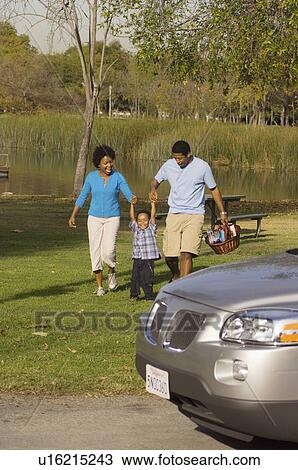 Family walking by river behind car View Large Photo Image Stock Image - Family walking by river behind car. Fotosearch