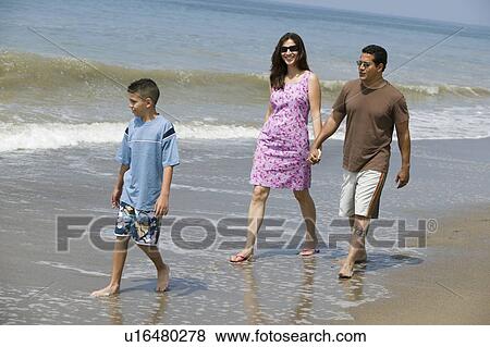 Stock Photo - Family walking on beach. Fotosearch