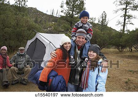 Family with children (7-12) camping, (portrait) View Large Photo Image Stock Photo - Family with children (7-12) camping, (portrait). Fotosearch