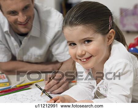 Father and daughter (3-4) colouring in book on floor, (portrait) View Large Photo Image Stock Image - Father and daughter (3-4) colouring in book on floor, (portrait). Fotosearch