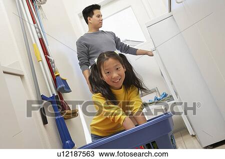 Father and daughter (7-9) doing laundry, portrait View Large Photo Image Stock Image - Father and daughter (7-9) doing laundry, portrait. Fotosearch