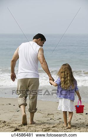 Father and daughter walking on beach View Large Photo Image Stock Image - Father and daughter walking on beach. Fotosearch