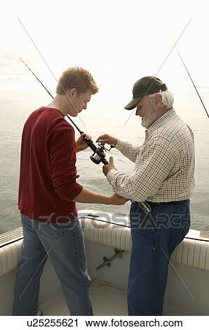 Father and son fishing on boat View Large Photo Image Stock Image - Father and son fishing on boat. Fotosearch