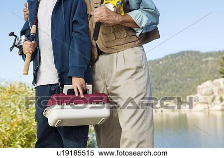 Father and son on fishing trip, (mid section) View Large Photo Image Stock Photography - Father and son on fishing trip, (mid section). Fotosearch