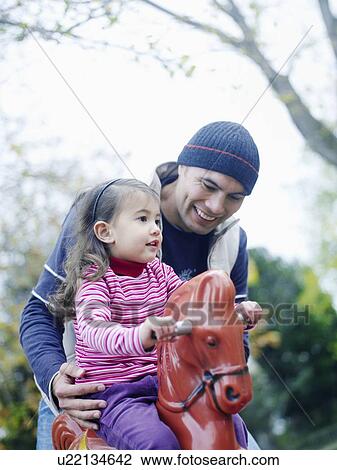 Stock Image - Father With Daughter at Playground. Fotosearch