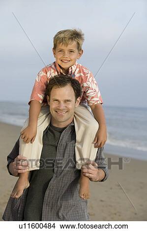 Picture - Father with Son on Shoulders at Beach. Fotosearch