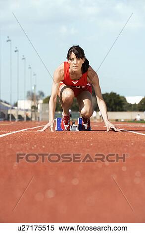 Female athlete on starting block View Large Photo Image Stock Photography - Female athlete on starting block. Fotosearch