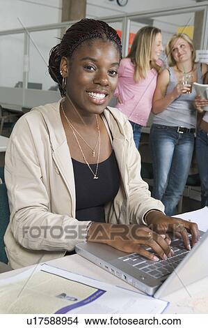 Picture - Female college student working on laptop. Fotosearch