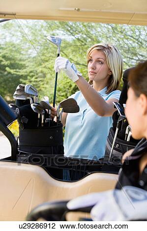 Female golfer choosing club from golf bag View Large Photo Image Stock Image - Female golfer choosing club from golf bag. Fotosearch