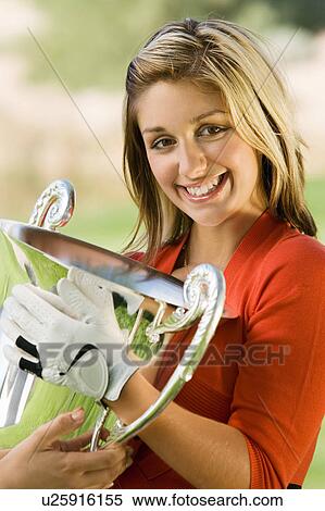 Female golfer receiving trophy, (portrait) View Large Photo Image Stock Photography - Female golfer receiving trophy, (portrait). Fotosearch