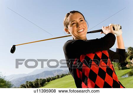 Female golfer swinging golf club View Large Photo Image Stock Photo - Female golfer swinging golf club. Fotosearch
