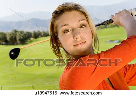 Female golfer swinging golf club, (close-up) View Large Photo Image Stock Photography - Female golfer swinging golf club, (close-up). Fotosearch