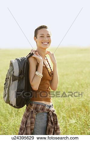 Female hiker standing in field, portrait View Large Photo Image Stock Photo - Female hiker standing in field, portrait. Fotosearch