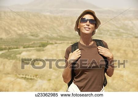 Stock Photography - Female hiker standing on top of mountain, portrait. Fotosearch