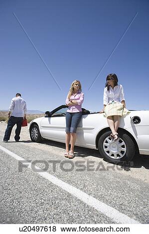 Female passengers send male driver for petrol View Large Photo Image Stock Photo - Female passengers send male driver for petrol. Fotosearch