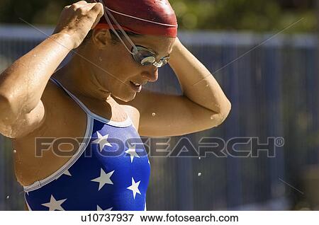 Female swimmer adjusting cap, (close-up) View Large Photo Image Stock Photo - Female swimmer adjusting cap, (close-up). Fotosearch