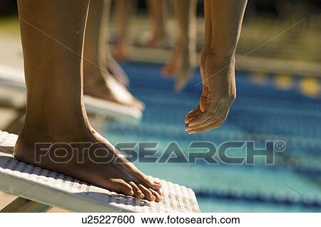 Female swimmers on starting blocks, (low section) View Large Photo Image Stock Image - Female swimmers on starting blocks, (low section). Fotosearch